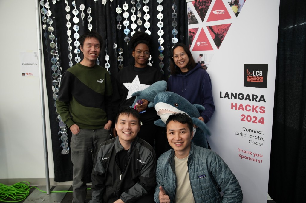 Team photo at Langara Hacks 2024 photobooth with event banner